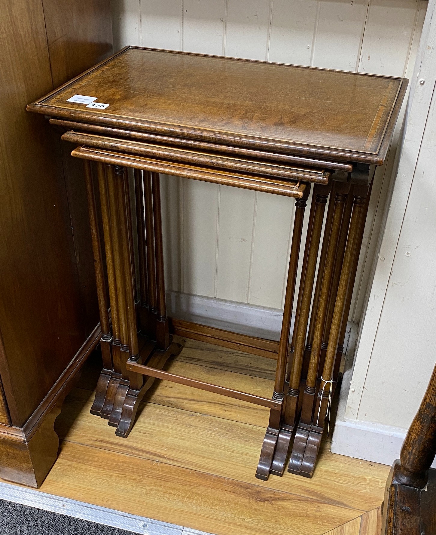 A nest of four Edwardian banded mahogany tea tables, width 55cm, depth 38cm, height 72cm